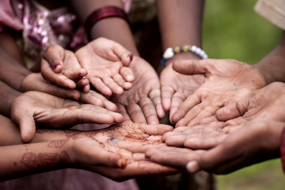 Children putting their hands together as a team